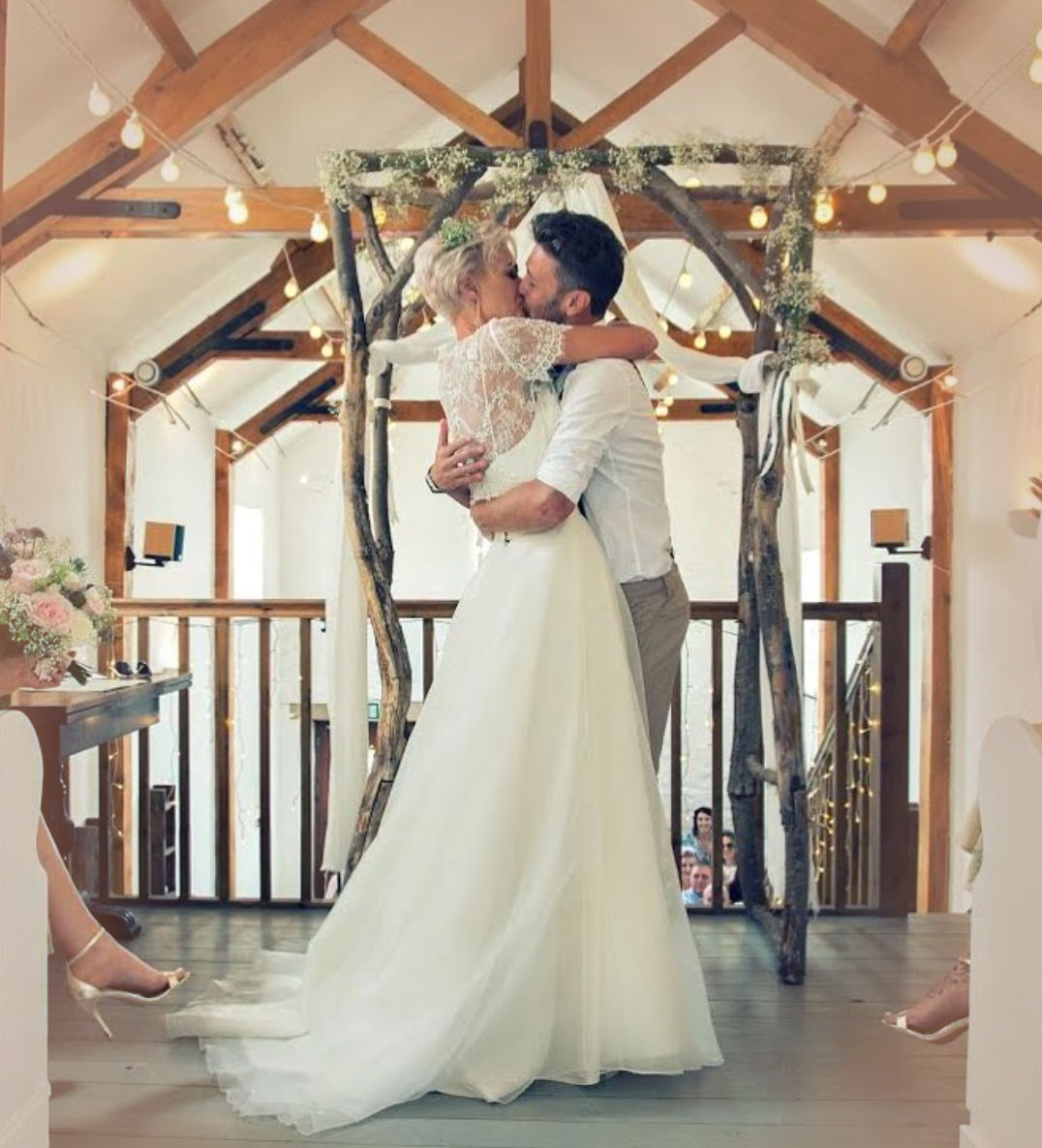 Happy couple kissing in Scarborough wedding barn